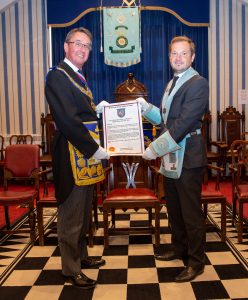 Centenary certificate being presented.